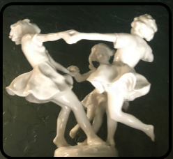 A statue of two people dancing in the dark.